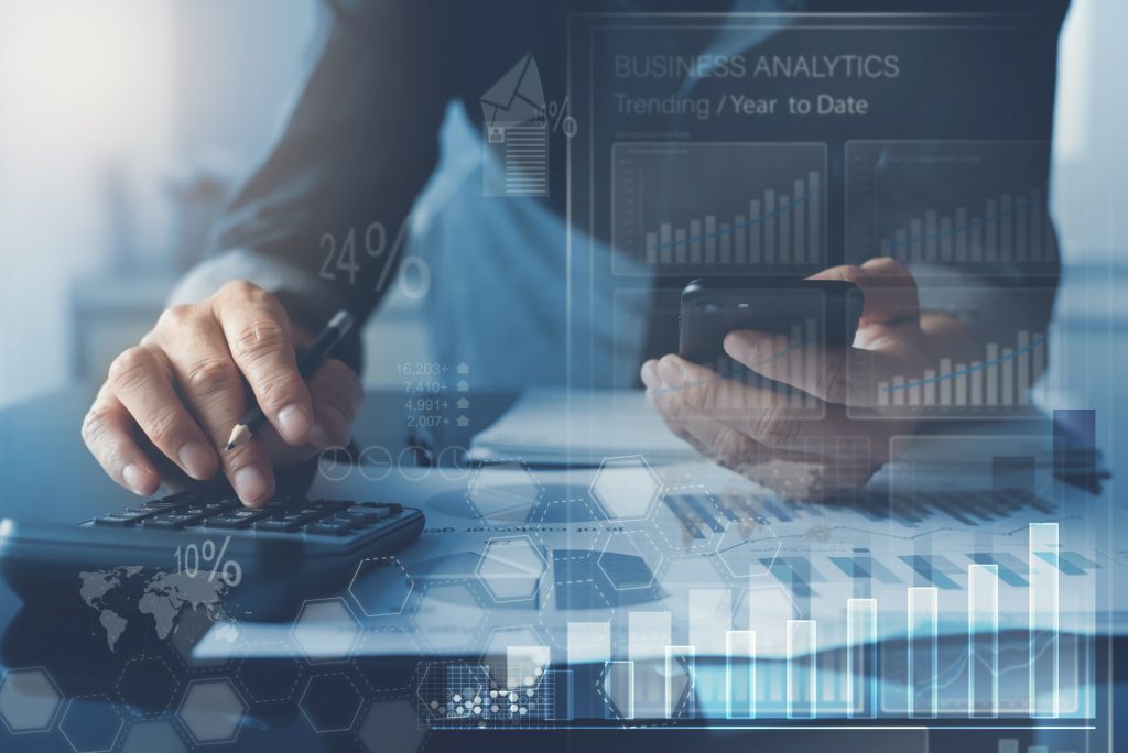 business man analysing market report with business analytics dashboard virtual screen